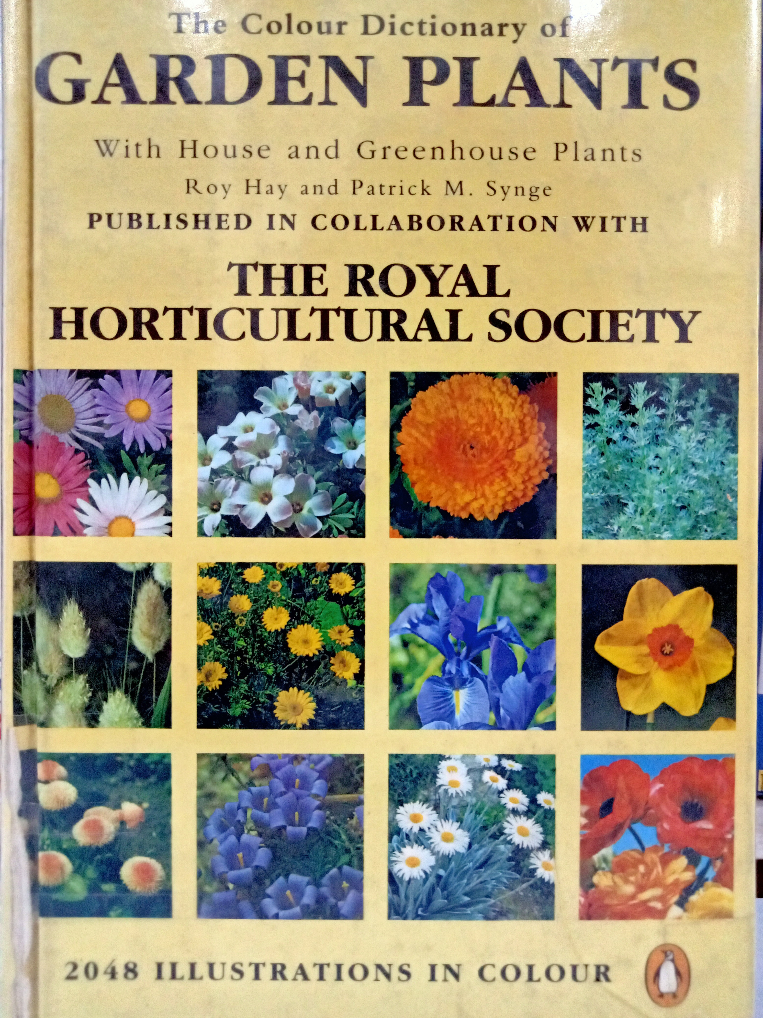 Book cover: The Colour dictionary of garden plants with house and green plants
